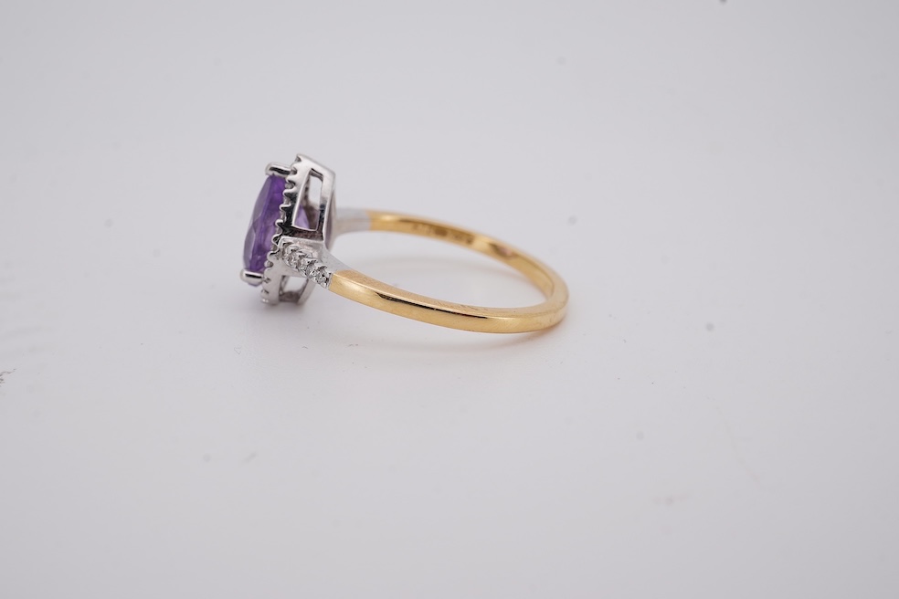 A modern 18ct gold and single stone pear cut amethyst set ring, with diamond chip set border and shoulders, size O, gross weight 3.4 grams. Condition - fair to good